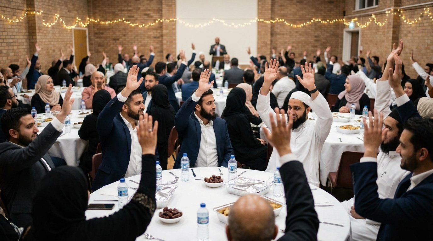 Audience at a charity fundraising dinner with hands raised during a pledge appeal — the moment of collective generosity